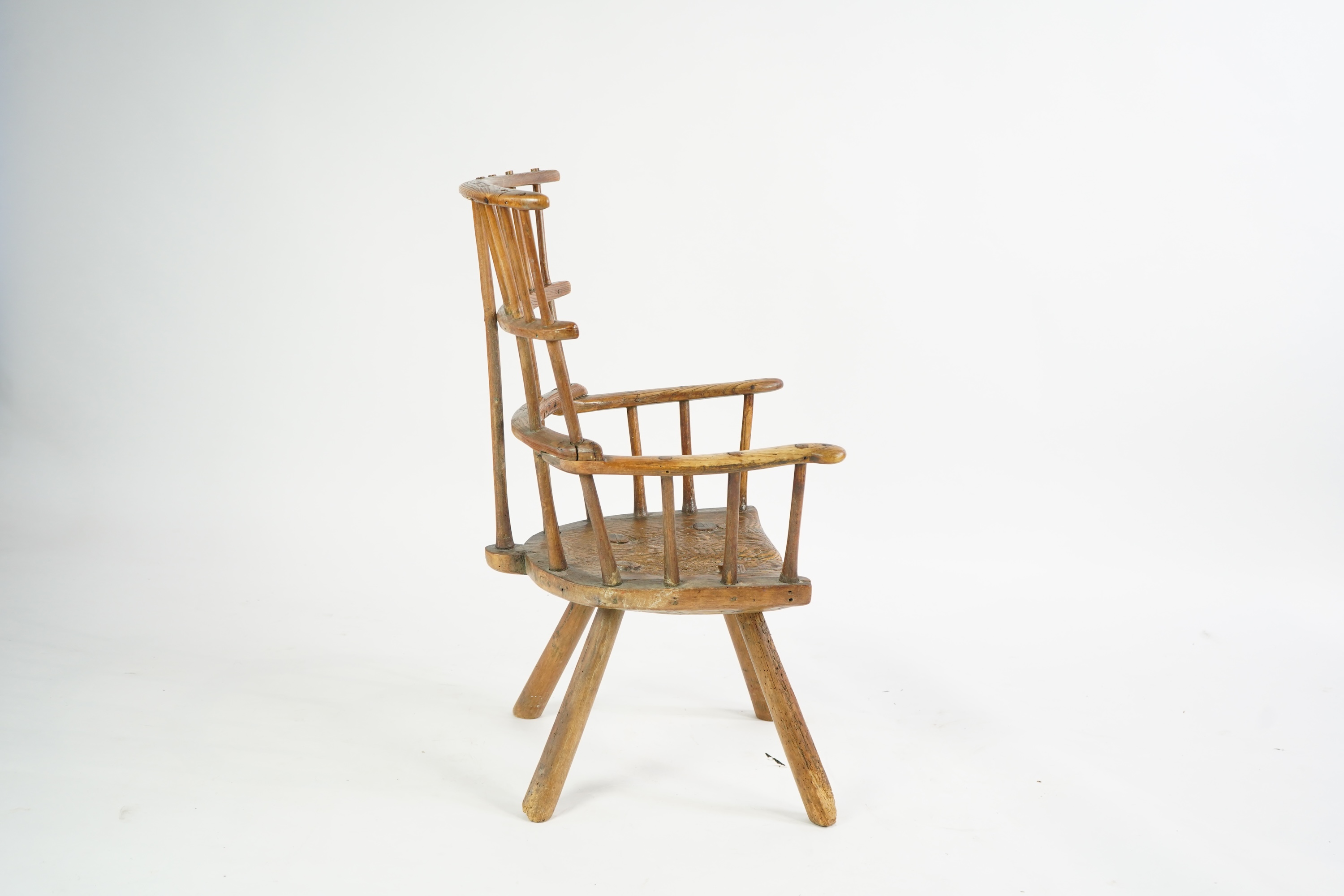 An 18th or 19th century primitive ash and elm Windsor armchair
